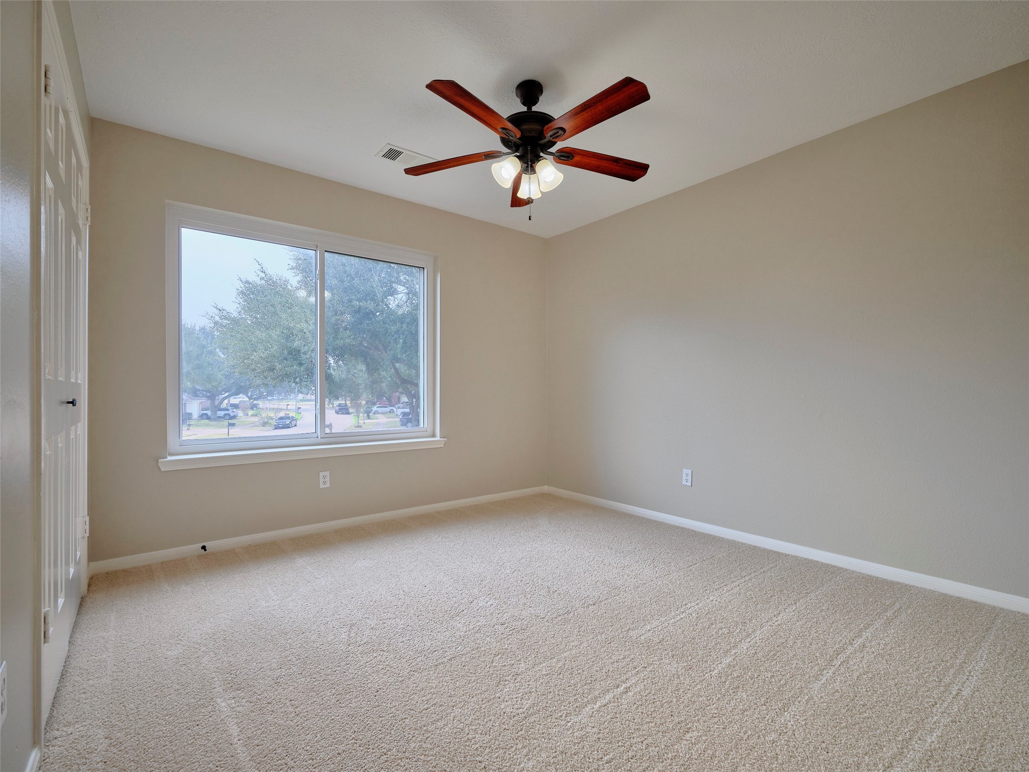 4801 East Columbary Drive Rosenberg, TX 77471 - Photo 38 of 50 an empty room with ceiling fan and windows