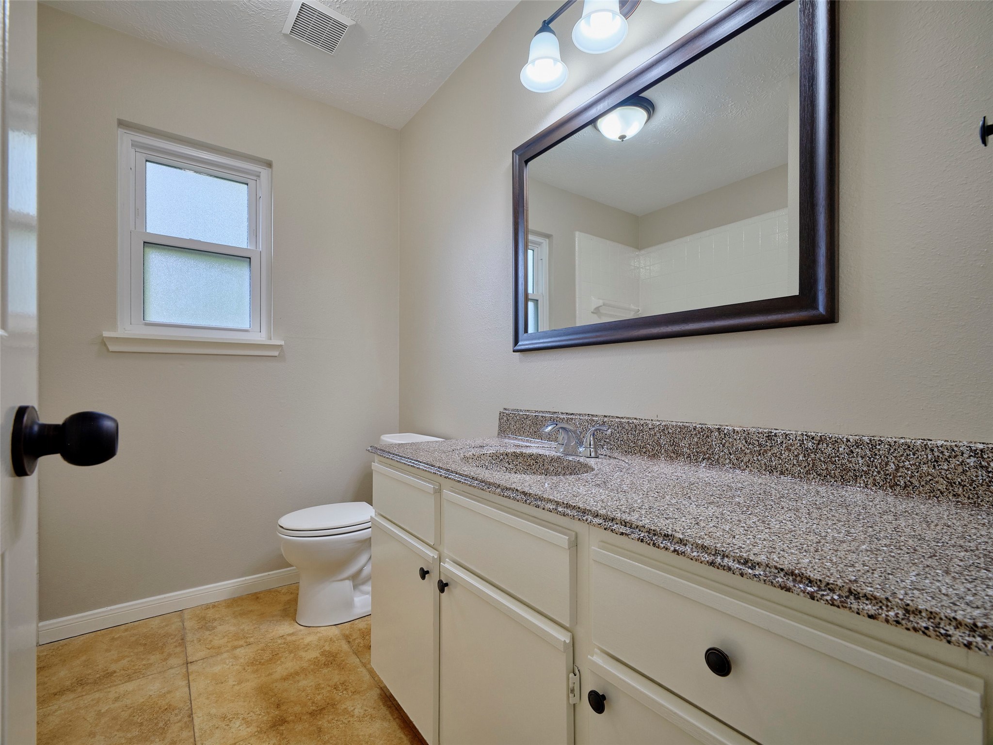 4801 East Columbary Drive Rosenberg, TX 77471 - Photo 40 of 50 a bathroom with a toilet sink and mirror