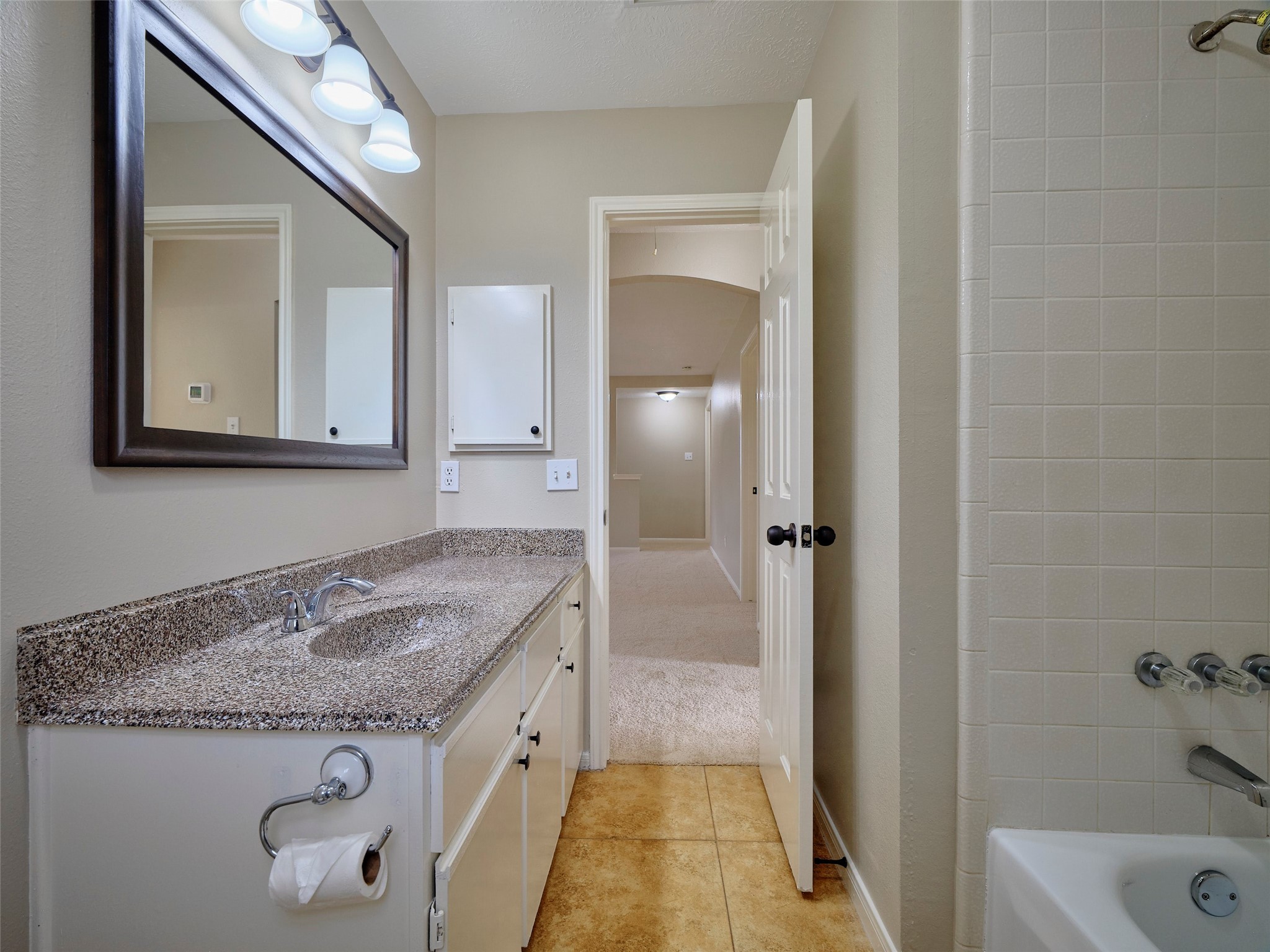 4801 East Columbary Drive Rosenberg, TX 77471 - Photo 41 of 50 a bathroom with a granite countertop sink and a mirror