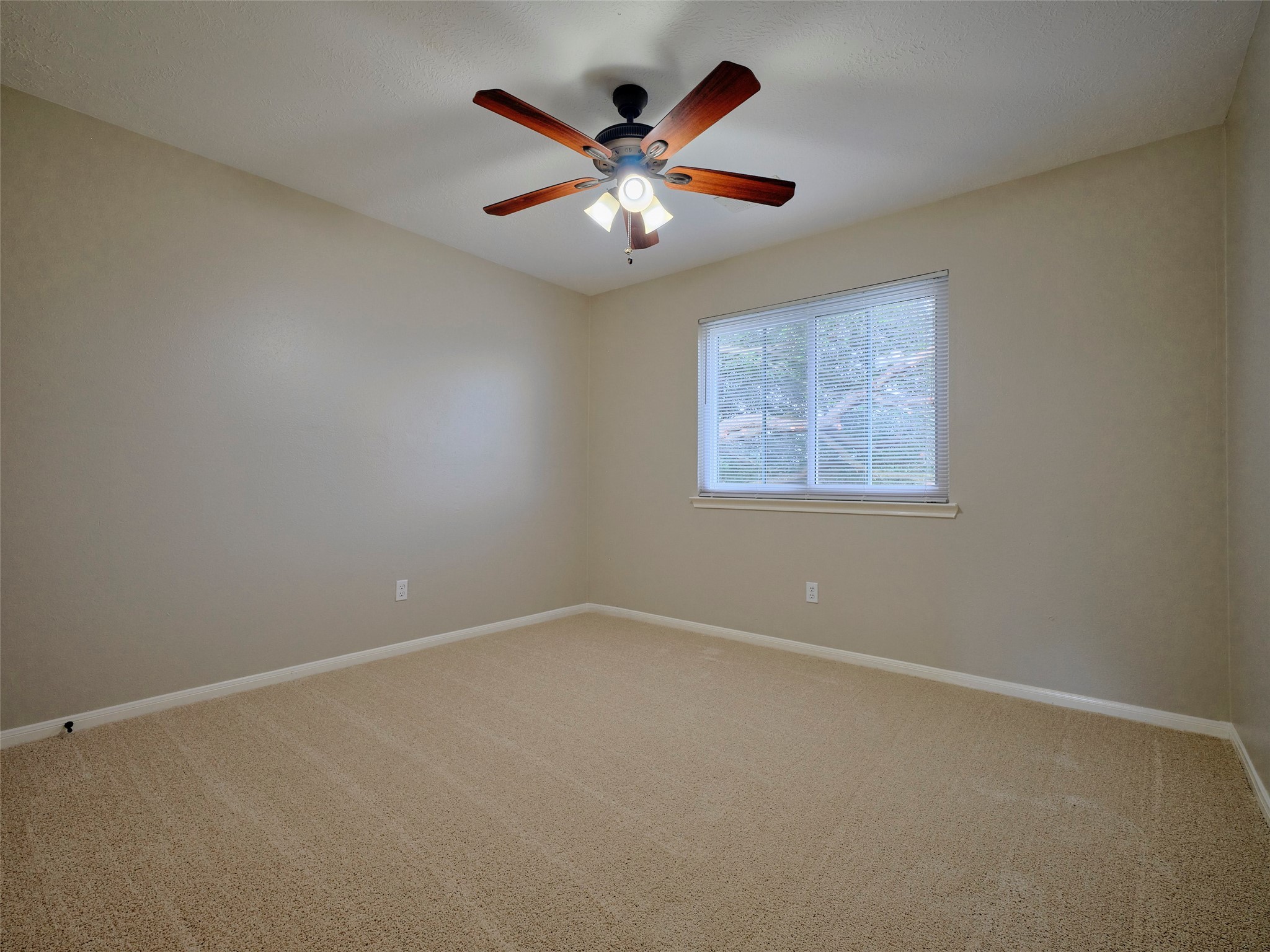 4801 East Columbary Drive Rosenberg, TX 77471 - Photo 42 of 50 an empty room with chandelier fan and windows