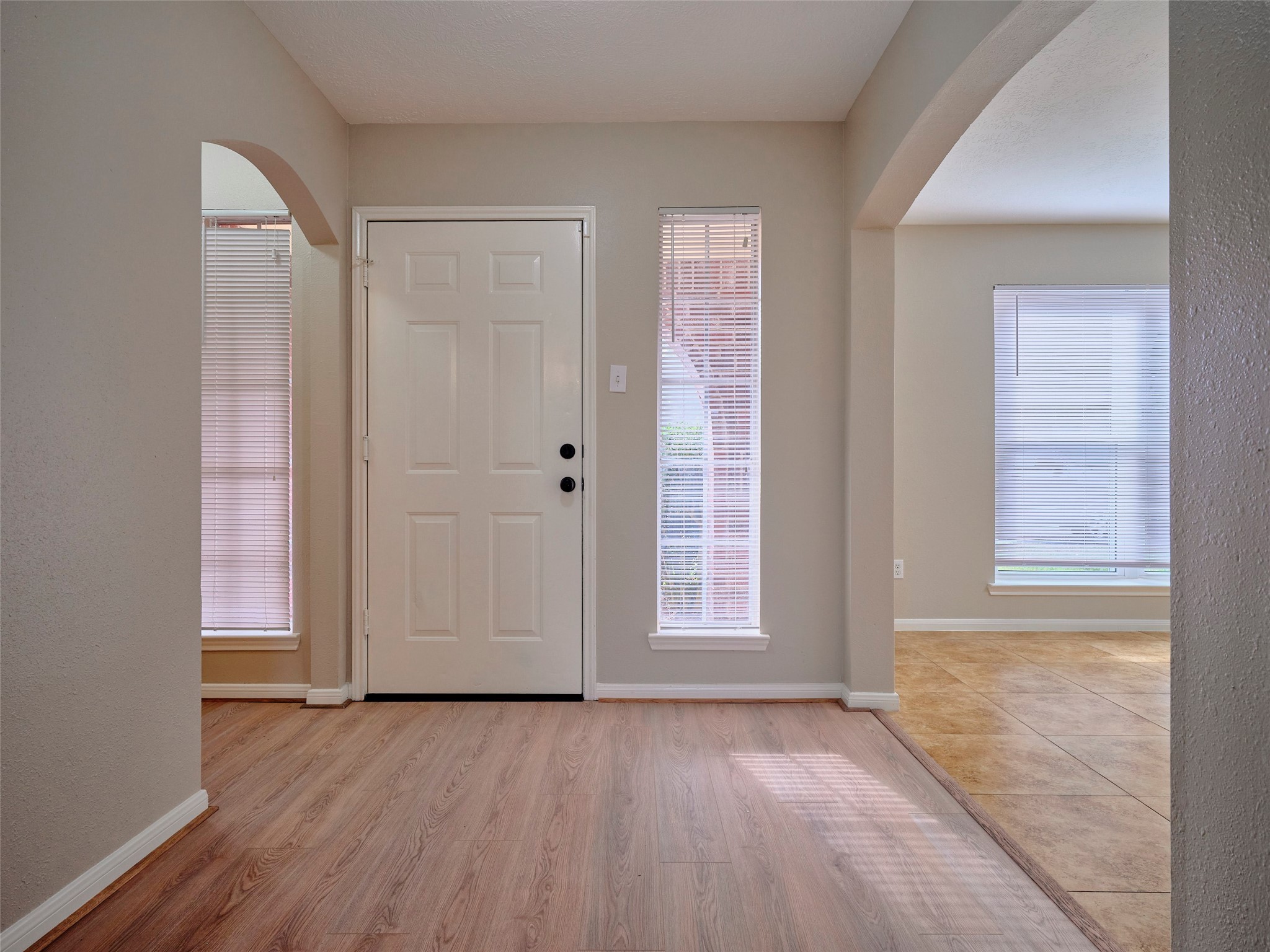 4801 East Columbary Drive Rosenberg, TX 77471 - Photo 6 of 50 an empty room with wooden floor and windows
