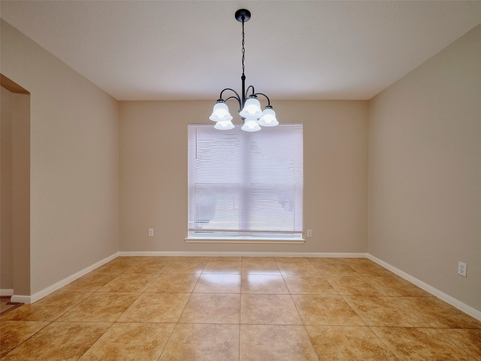 4801 East Columbary Drive Rosenberg, TX 77471 - Photo 8 of 50 a view of a room with a chandelier and glass windows
