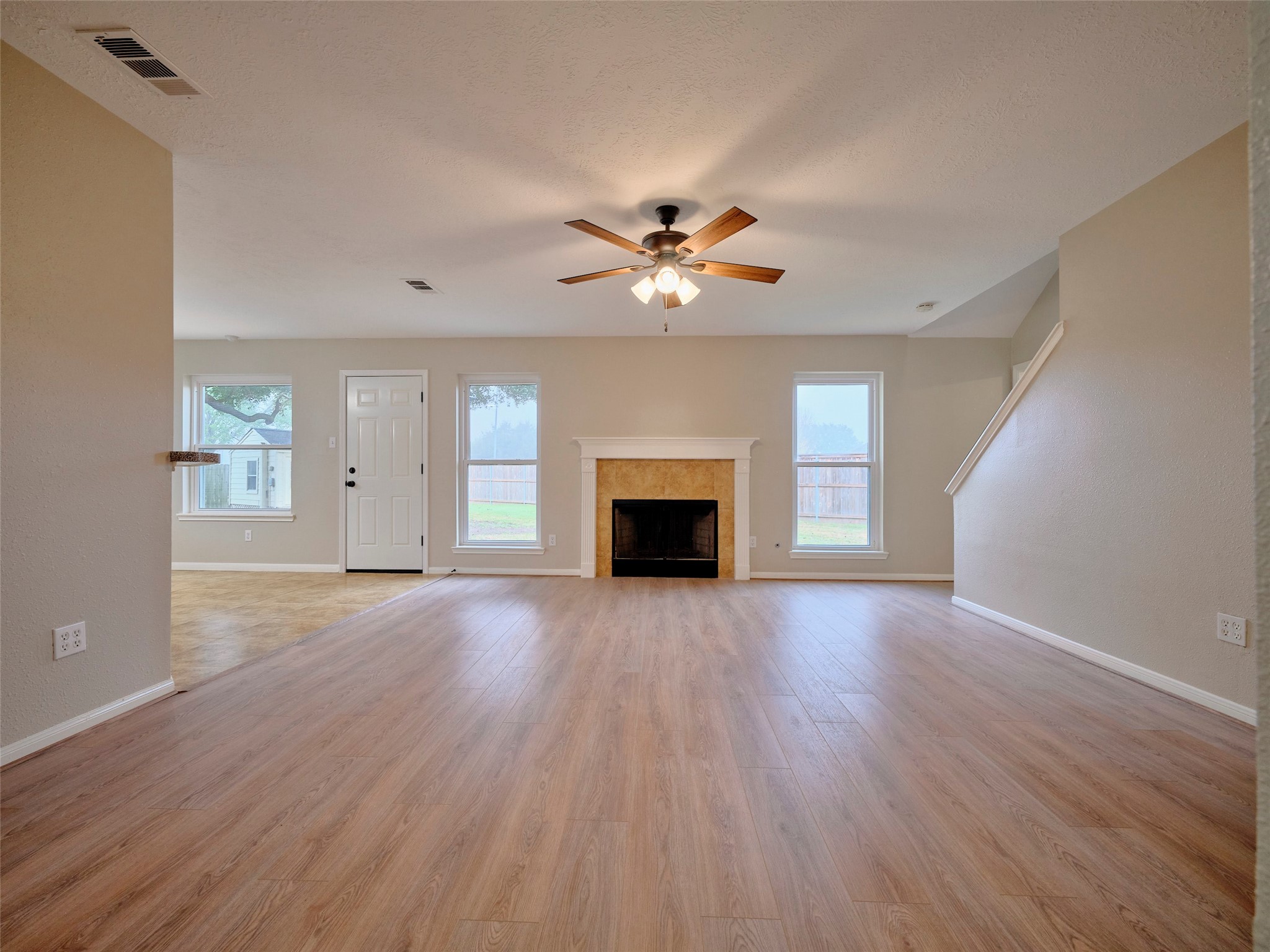 4801 East Columbary Drive Rosenberg, TX 77471 - Photo 9 of 50 a view of an empty room with a fireplace and a window