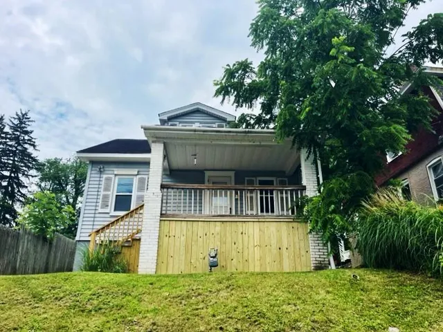 a front view of a house with a garden