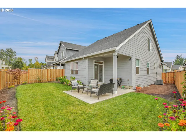 a backyard of a house with table and chairs
