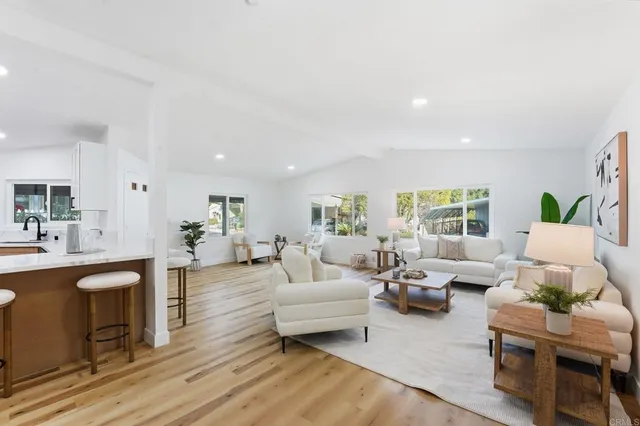 a living room with fireplace furniture and a wooden floor