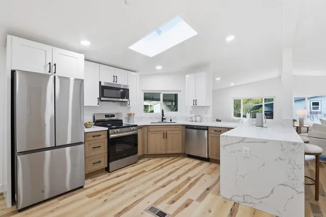 a kitchen with a refrigerator stove and sink