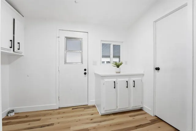 a view of an entryway with wooden floor
