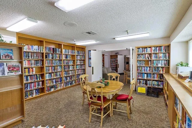 a reading room with furniture window and book shelf