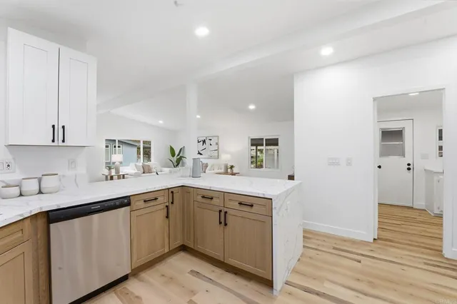 a kitchen with a sink cabinets and wooden floor