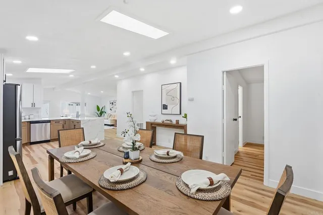 a dining room with furniture and wooden floor