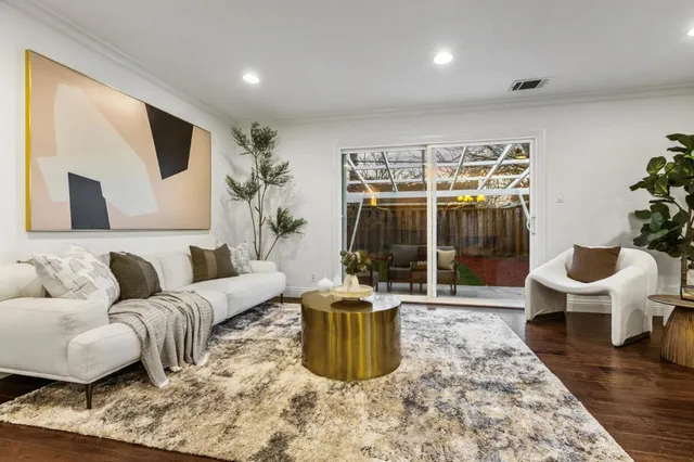 a vase of flowers sitting on a table with wooden floor