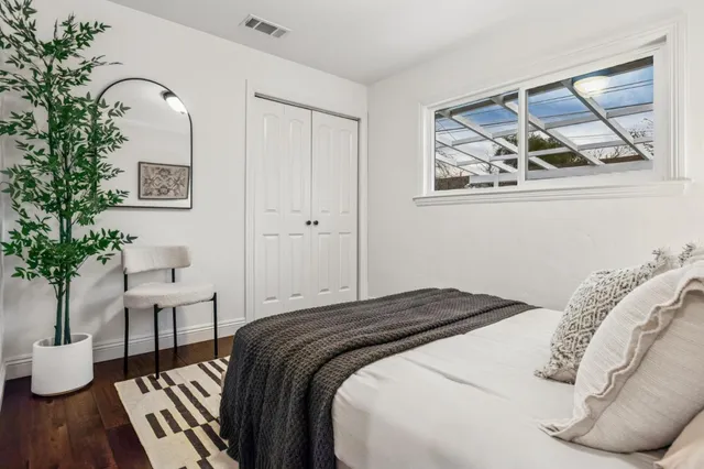 a living room with furniture wooden floor and kitchen view