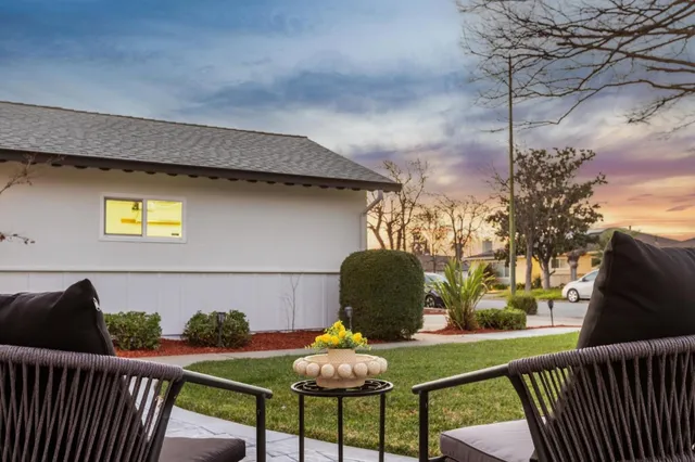 a front view of a house with a garden