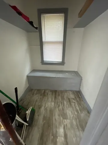 a view of wooden floor and chair in a room