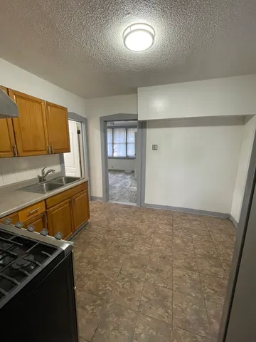 a kitchen with granite countertop a stove and a refrigerator