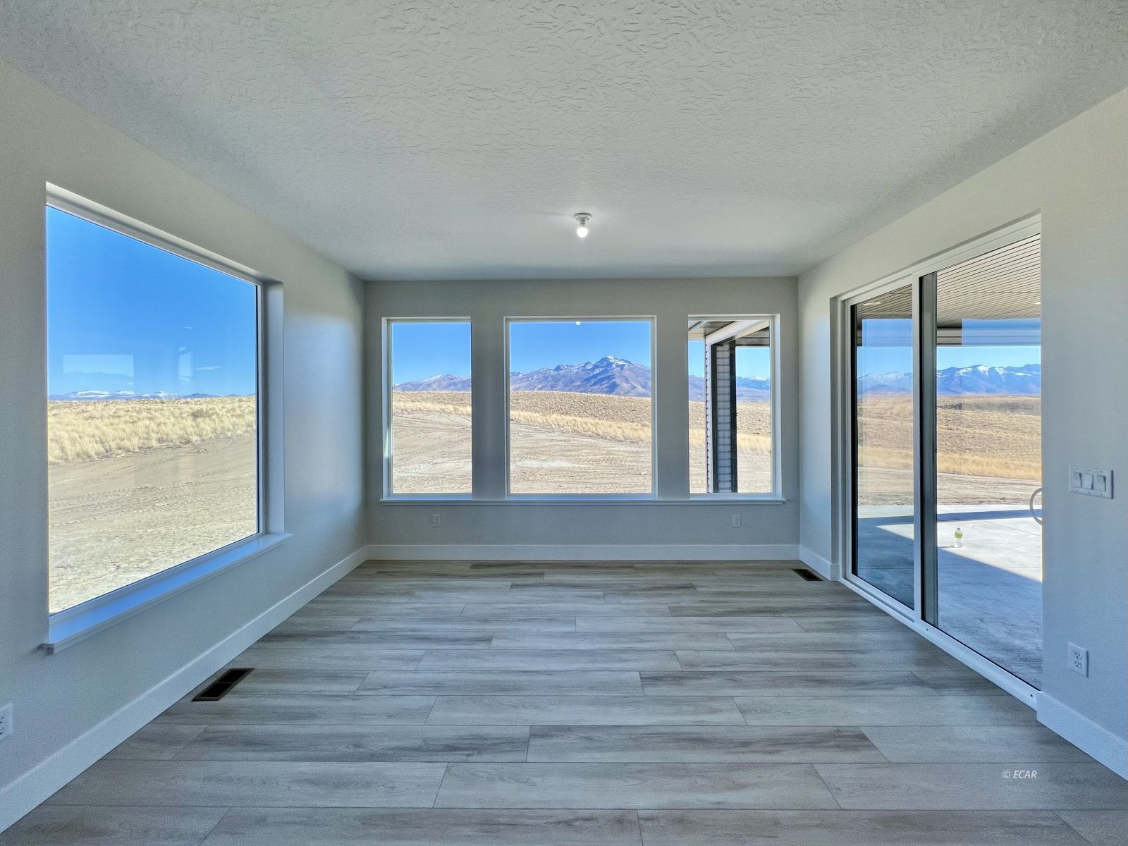 1597 Sun Vly Road, Unit C7 Spring Creek, NV 89815 - Photo 15 of 43 a view of an empty room with wooden floor and a window