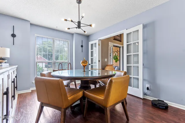 a view of a workspace with furniture and wooden floor
