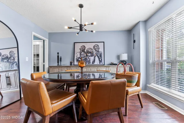 a view of a dining room with furniture window and wooden floor