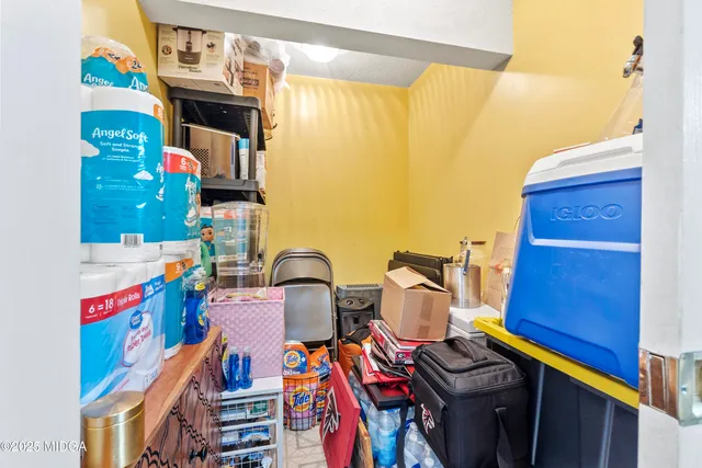 a bed room with a bed a television and a large window
