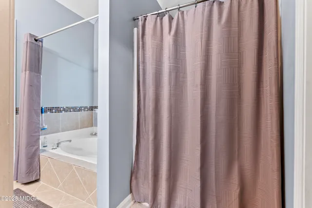 a bed room with a bed and a television