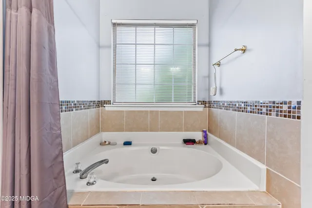 a bathroom with a double vanity sink toilet and a mirror