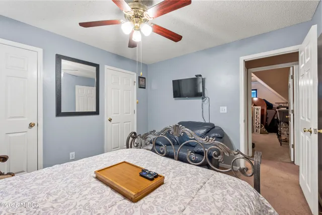 a bedroom with a bed and glass door