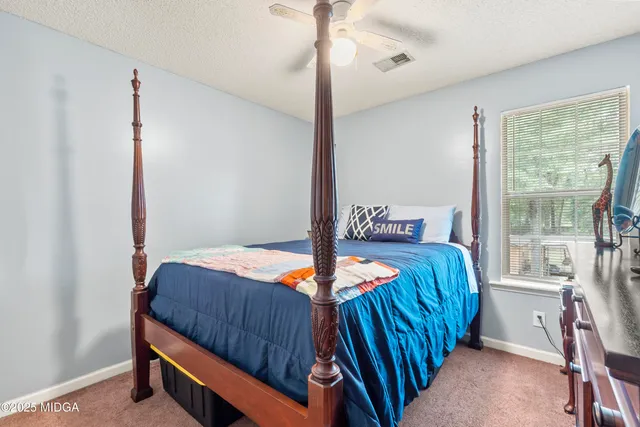 a view of a kitchen with a window and a clock on the wall