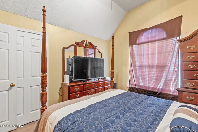 a view of a swimming pool with lawn chairs and a barbeque