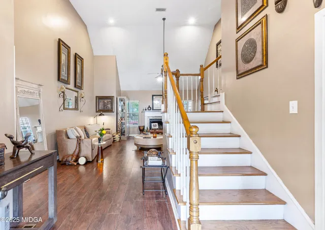 a living room with fireplace furniture and a wooden floor