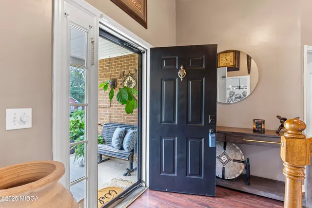 a living room with furniture a fireplace and wooden floor