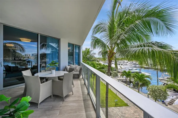 a view of a chairs and table in patio with a swimming pool