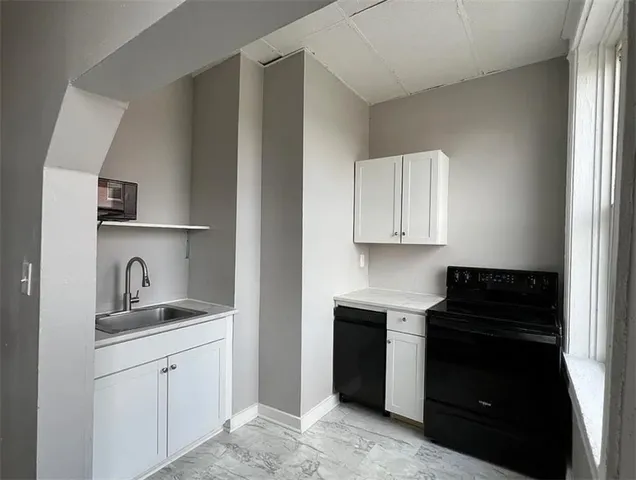 a kitchen with a stove and a microwave