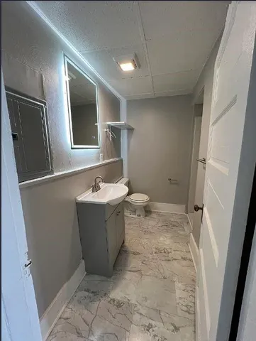 an empty room with windows and fireplace