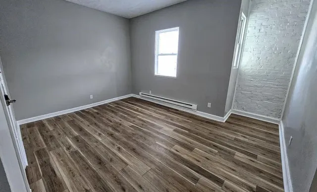 a view of room with window and hardwood floor