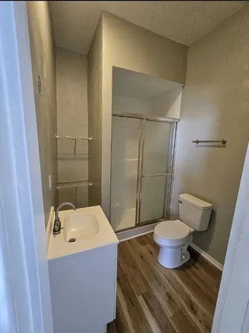 a bathroom with a sink toilet and shower
