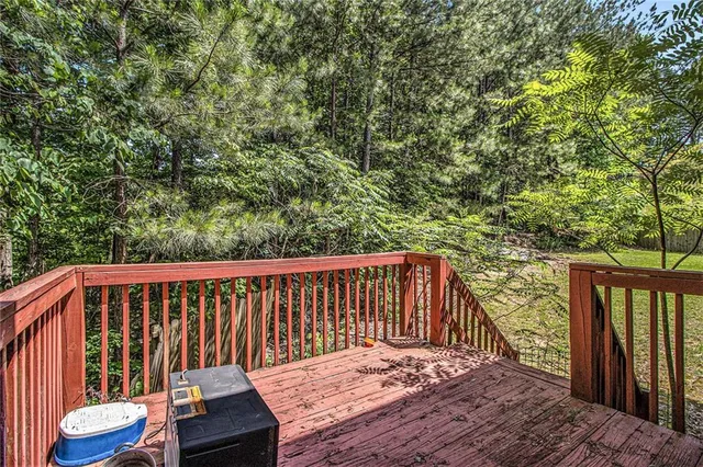 a balcony with wooden floor and outdoor space