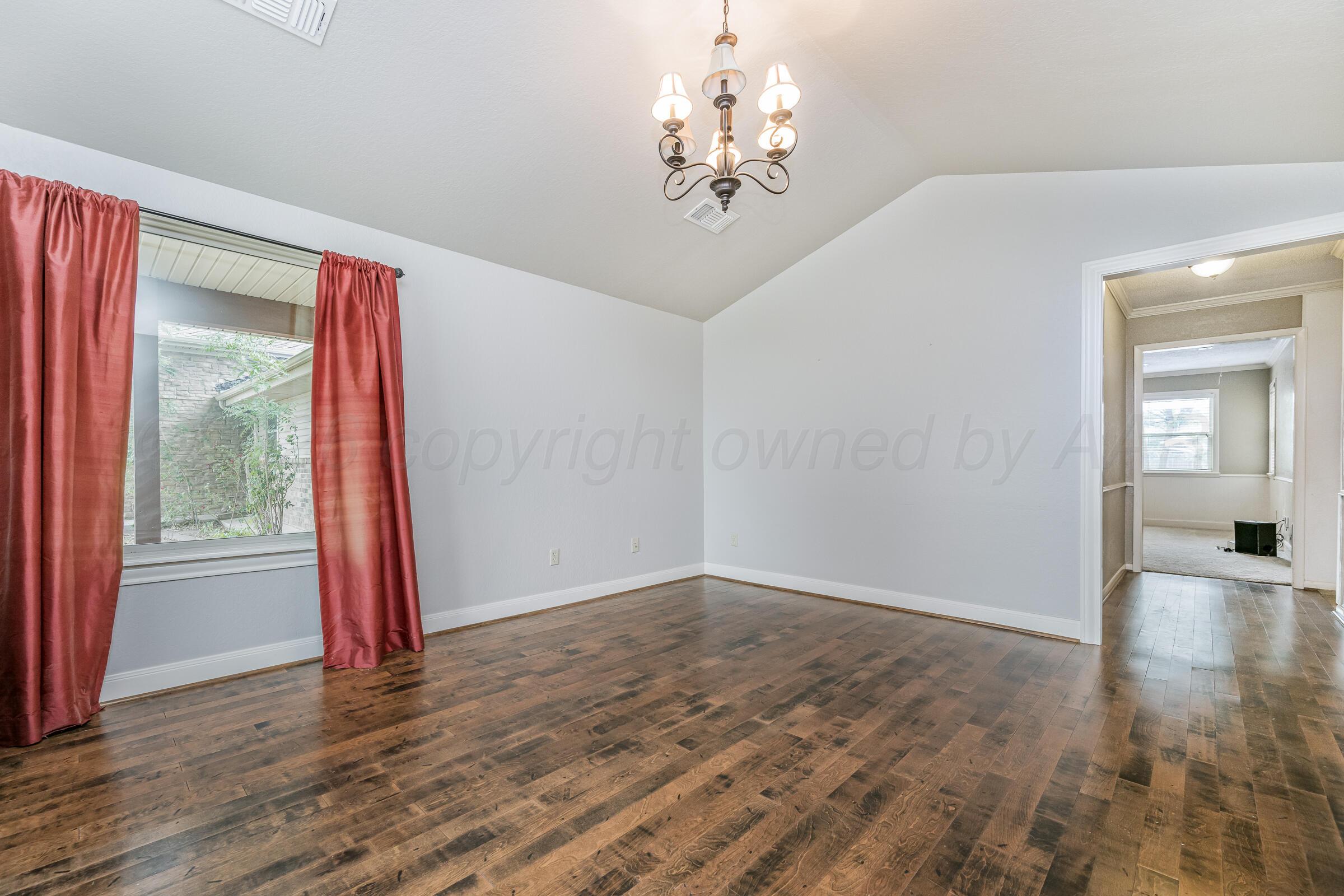 4400 West Farmers Avenue Amarillo, TX 79110 - Photo 6 of 27 wooden floor in an empty room with a window