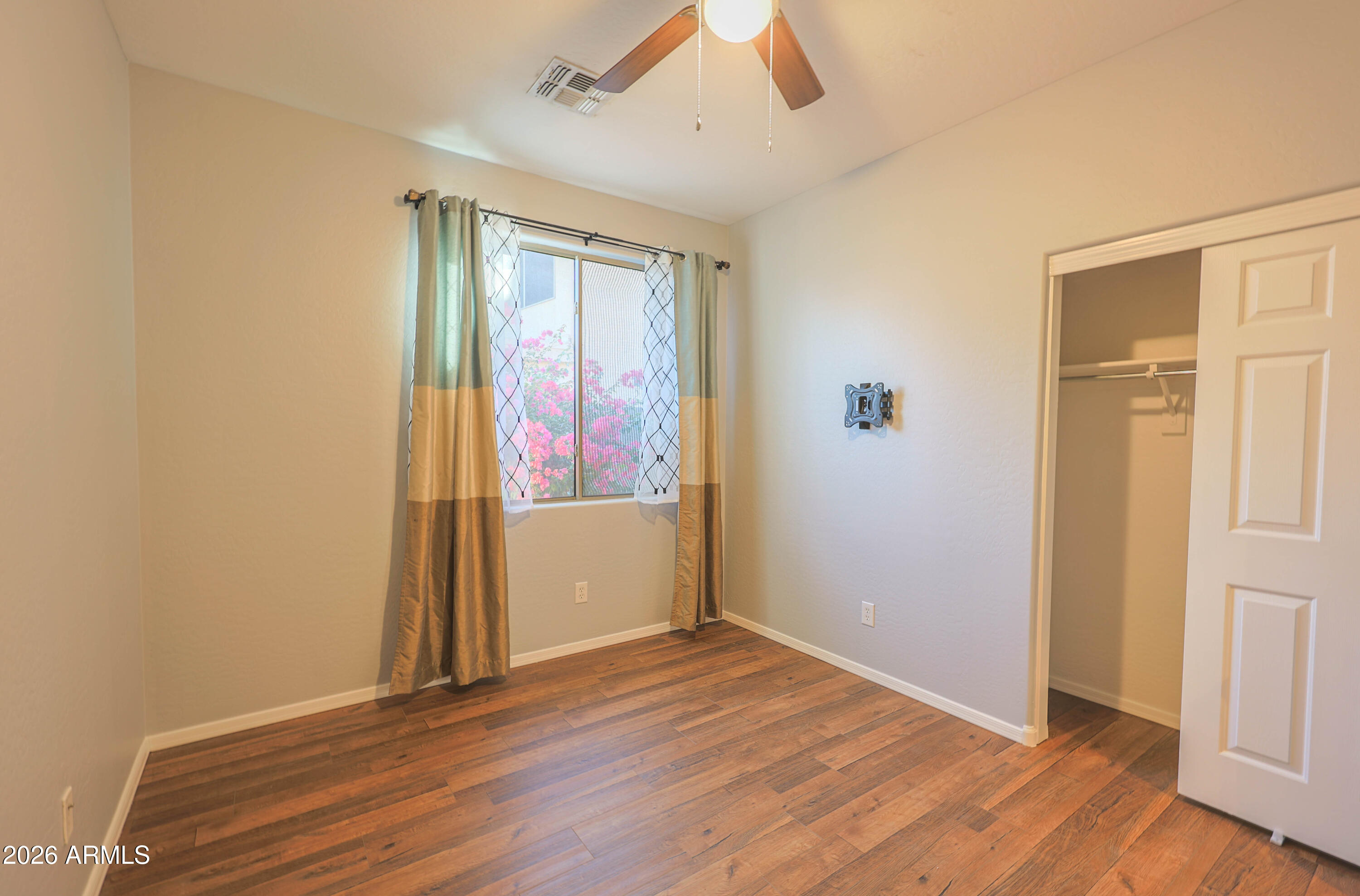 40735 North Trailhead Way Anthem, AZ 85086 - Photo 16 of 36 an empty room with wooden floor and windows