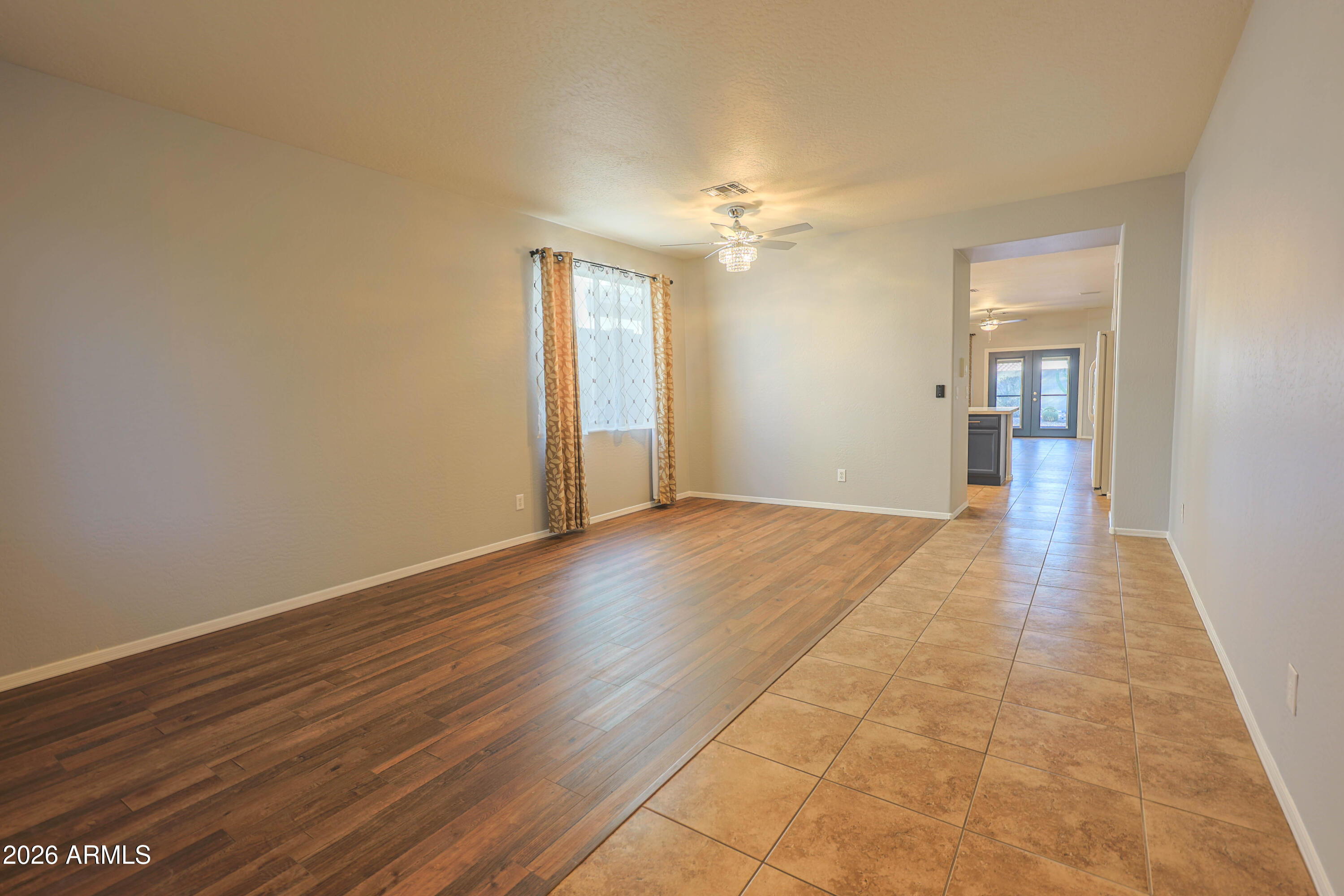 40735 North Trailhead Way Anthem, AZ 85086 - Photo 9 of 36 an empty room with wooden floor and windows