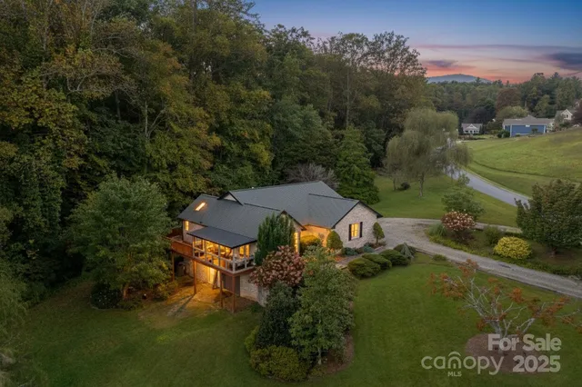 an aerial view of a house with garden space ocean and mountain view