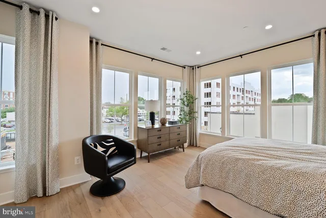 a bedroom with a bed and a painting on the wall