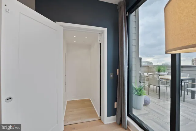 a spacious bedroom with a bed and large windows