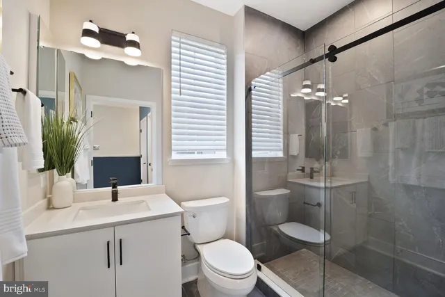a bathroom with a sink vanity and a mirror