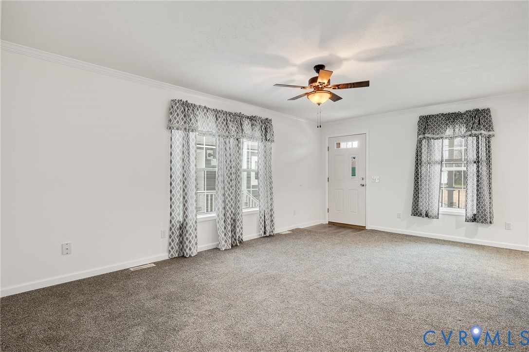 751 South Jones Street Petersburg, VA 23803 - Photo 4 of 13 an empty room with chandelier fan and windows
