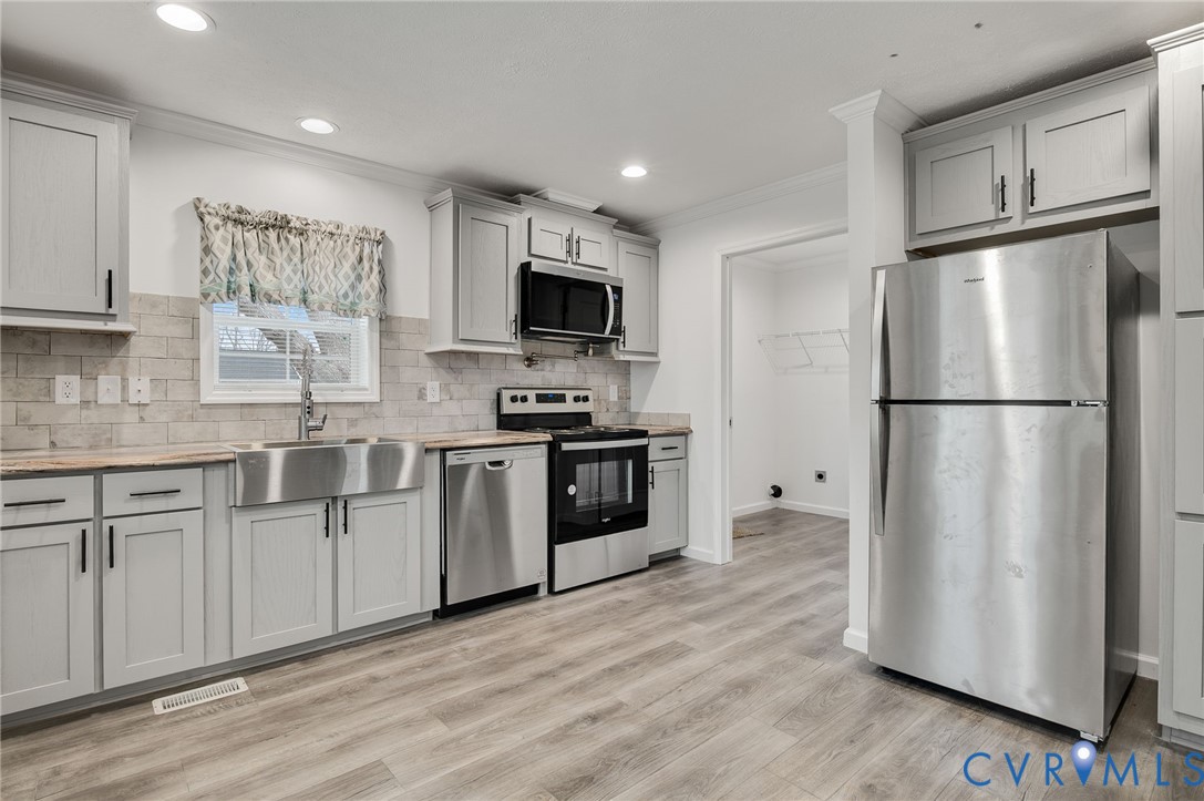 751 South Jones Street Petersburg, VA 23803 - Photo 5 of 13 a kitchen with stainless steel appliances a refrigerator sink and microwave