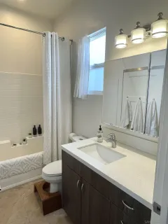 a bathroom with a sink a toilet and bathtub