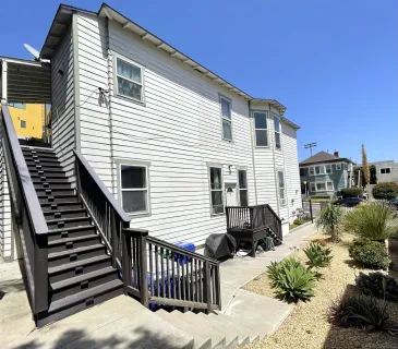 a view of a house with wooden deck