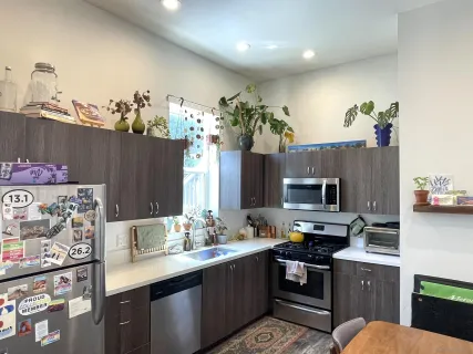 a living room with lots of furniture and a wooden floor