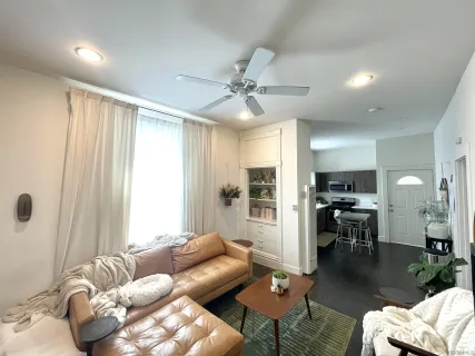 a living room with furniture and a large window